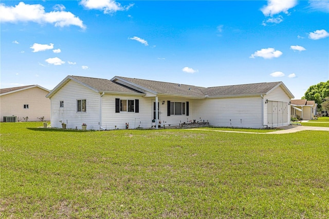 ranch-style home featuring central AC unit and a front yard