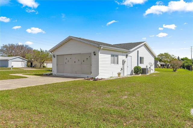 view of home's exterior with driveway, a shingled roof, a lawn, an attached garage, and central AC