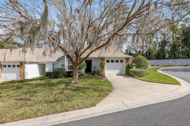 view of front of property with a front yard, driveway, and an attached garage