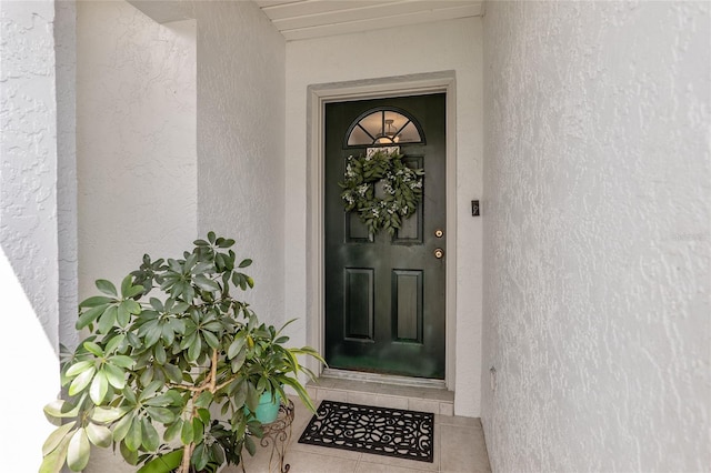 entrance to property with stucco siding