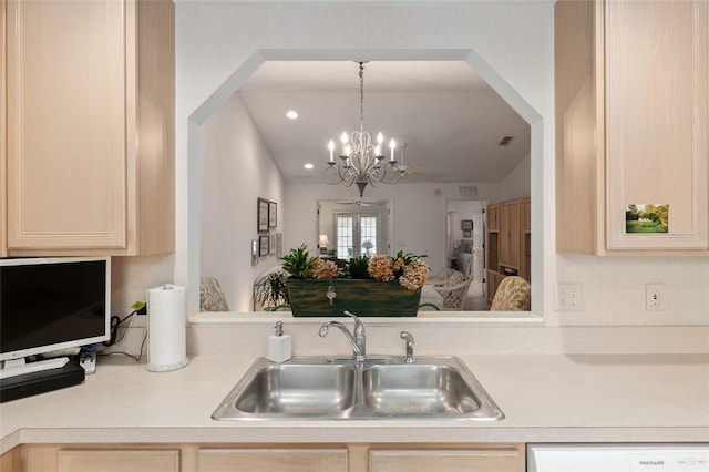 kitchen featuring white dishwasher, a sink, visible vents, light countertops, and light brown cabinetry