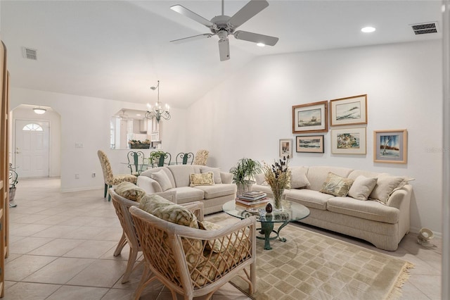 living area with arched walkways, light tile patterned floors, lofted ceiling, and visible vents