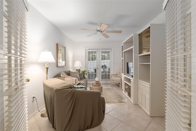 living area featuring ceiling fan and light tile patterned floors