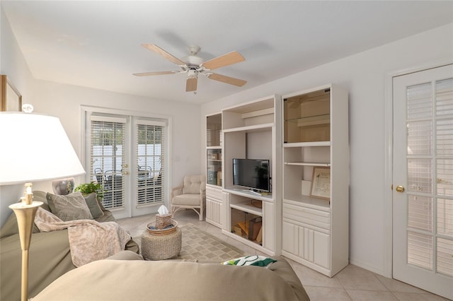 living area with ceiling fan and light tile patterned flooring