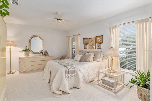 bedroom featuring carpet, visible vents, and a ceiling fan