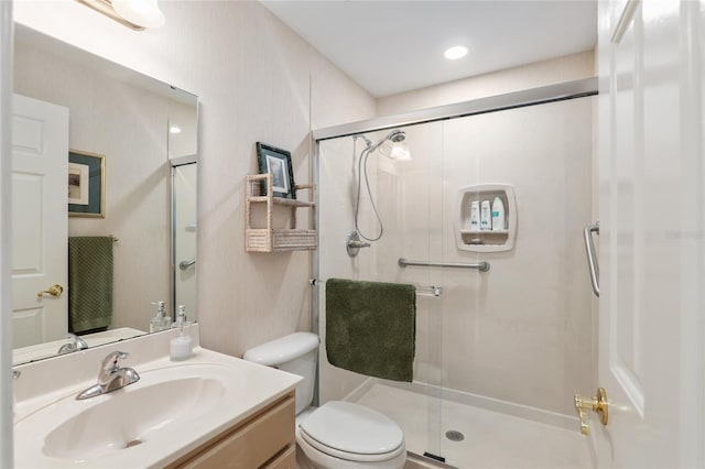 full bath with toilet, a shower stall, and vanity