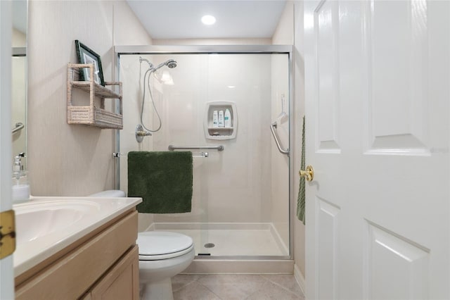 bathroom with a stall shower, vanity, and tile patterned floors