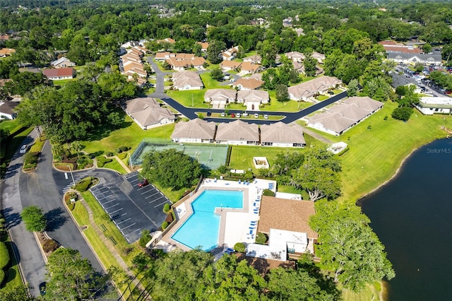 birds eye view of property with a residential view and a water view