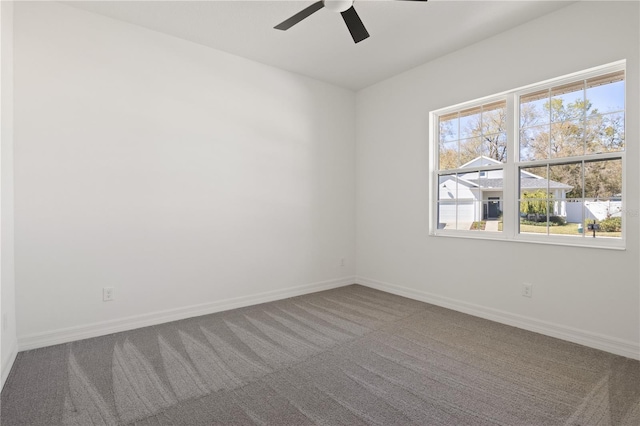 spare room with carpet floors, baseboards, and a ceiling fan