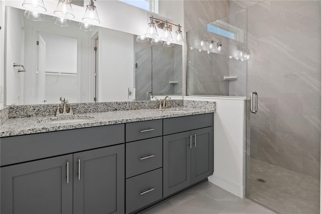 bathroom featuring double vanity, marble finish floor, a sink, and a stall shower