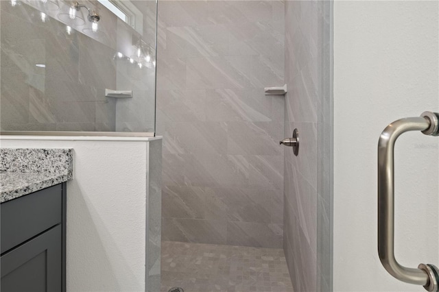 bathroom with a walk in shower and vanity