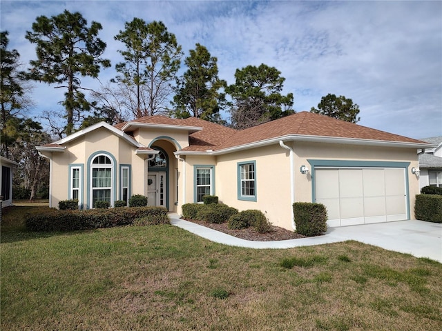 mediterranean / spanish-style home featuring driveway, a front lawn, an attached garage, and stucco siding