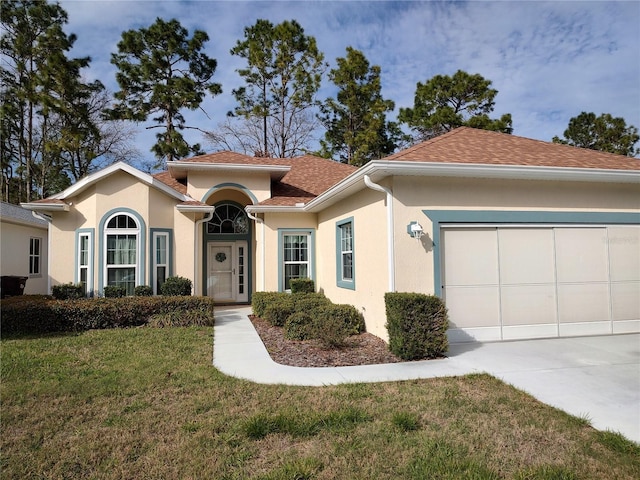 view of front facade with a garage, concrete driveway, a front lawn, and stucco siding