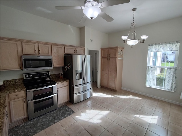 kitchen with stainless steel appliances, light brown cabinets, vaulted ceiling, and light tile patterned floors