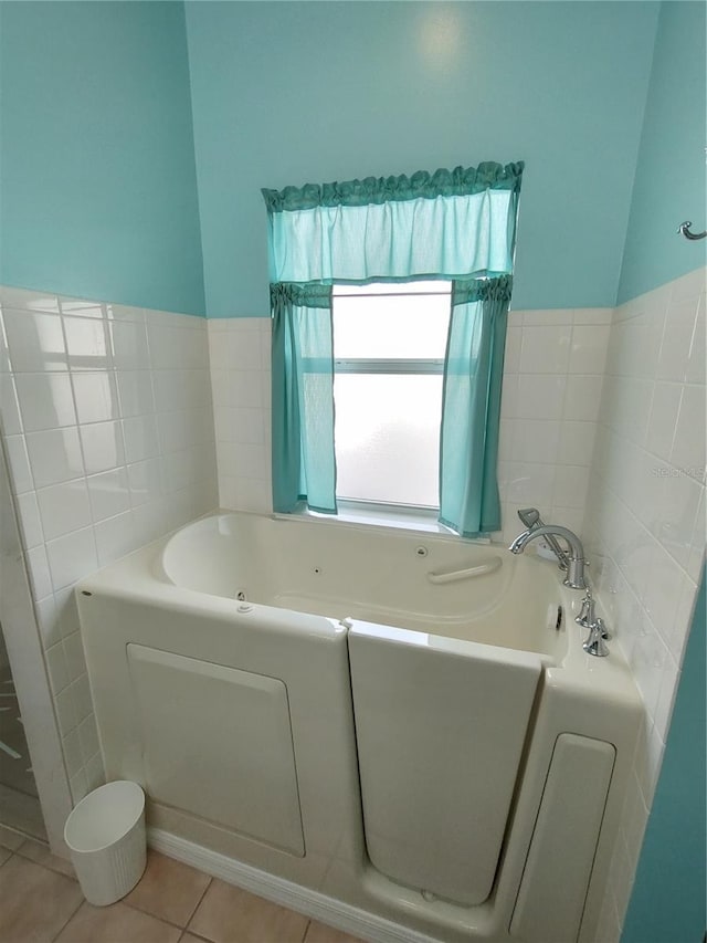 bathroom featuring tile patterned flooring and a bath