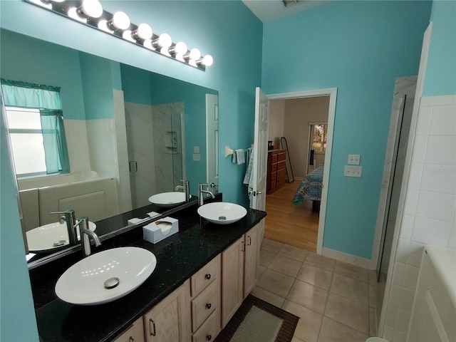 full bath featuring a sink and tile patterned floors