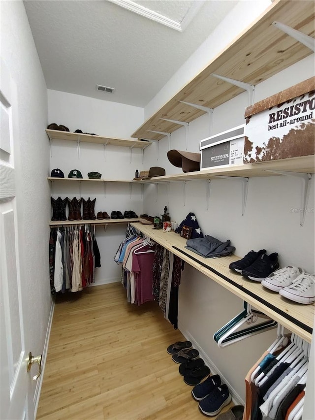 walk in closet featuring light wood finished floors and visible vents