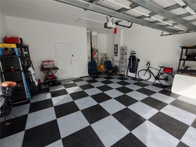 garage with a garage door opener and electric panel