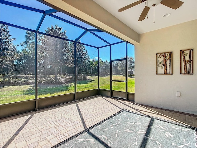 unfurnished sunroom featuring ceiling fan