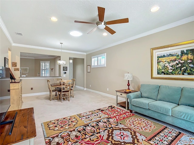 living room with baseboards, visible vents, crown molding, and light colored carpet