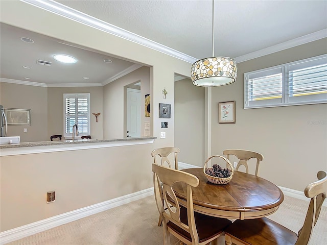 dining area with light carpet, baseboards, visible vents, and crown molding