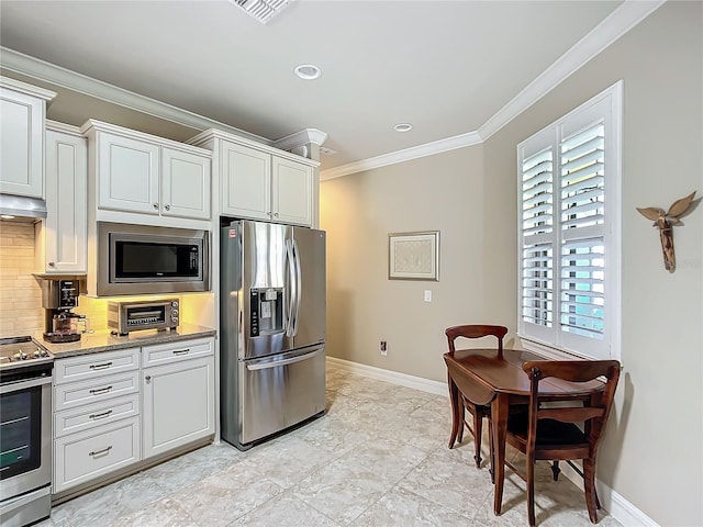 kitchen with stainless steel appliances, white cabinets, crown molding, and decorative backsplash