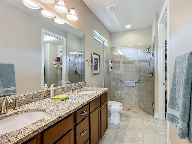 bathroom with a stall shower, visible vents, a sink, and toilet