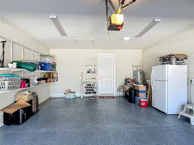 garage with water heater, concrete block wall, freestanding refrigerator, and a garage door opener