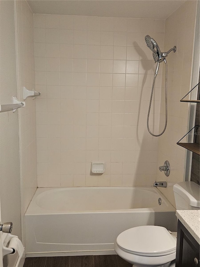 full bathroom featuring tub / shower combination, vanity, toilet, and wood finished floors