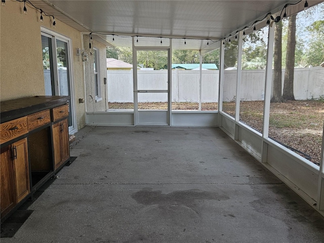 unfurnished sunroom featuring a healthy amount of sunlight