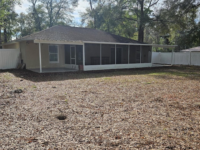 back of property with a patio, fence, and a sunroom