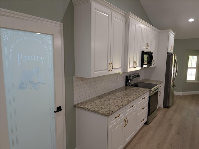 kitchen with light wood-style floors, decorative backsplash, white cabinetry, and appliances with stainless steel finishes