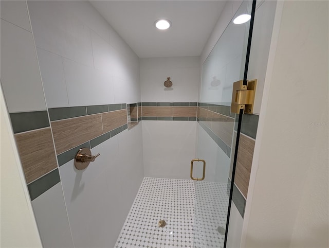full bathroom with recessed lighting, a stall shower, and tile walls
