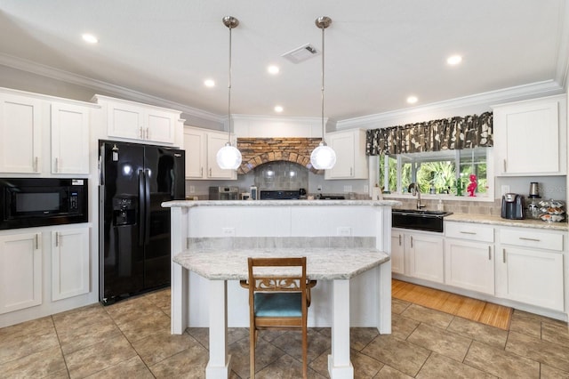 kitchen with black appliances, a kitchen island, white cabinets, and pendant lighting