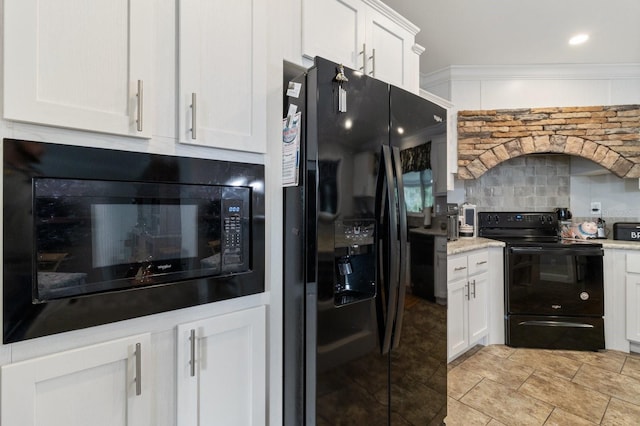 kitchen with light stone counters, white cabinetry, ornamental molding, backsplash, and black appliances