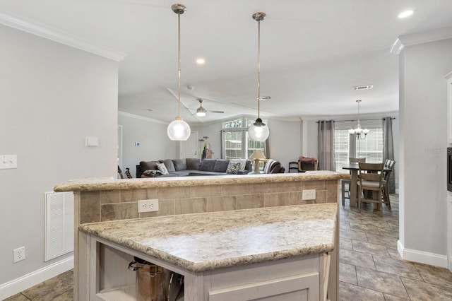 kitchen featuring visible vents, ornamental molding, open floor plan, a center island, and pendant lighting