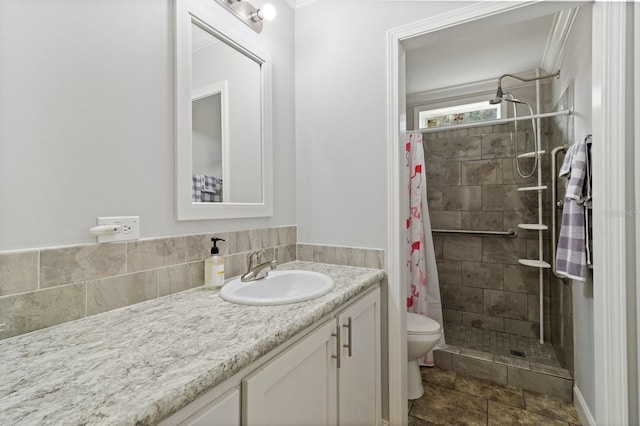 bathroom featuring toilet, a shower stall, and vanity