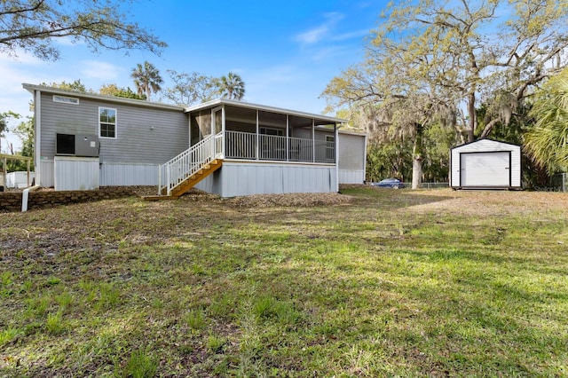 back of house with a sunroom, a yard, stairs, a storage unit, and an outdoor structure