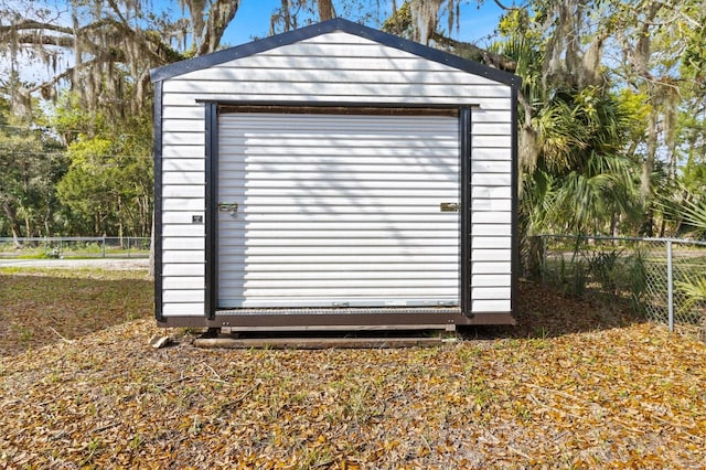 view of shed featuring fence