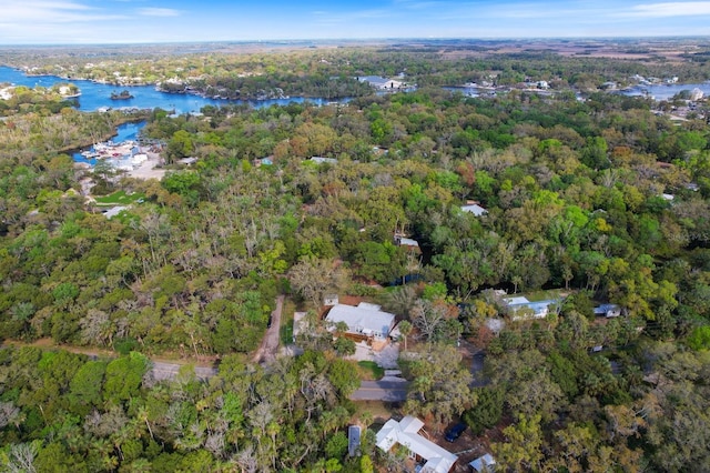 aerial view with a water view and a forest view