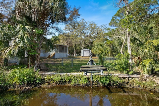 dock area with a water view and fence