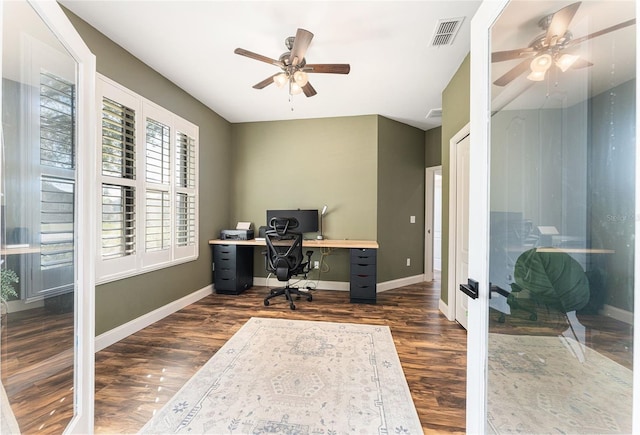 home office featuring baseboards, visible vents, ceiling fan, and dark wood-type flooring