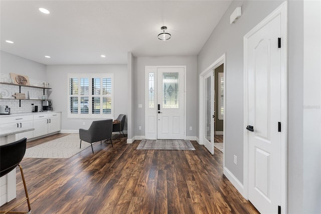 entryway with baseboards, dark wood finished floors, and recessed lighting