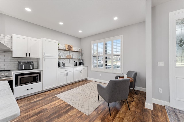 kitchen with decorative backsplash, stainless steel appliances, light countertops, white cabinetry, and open shelves