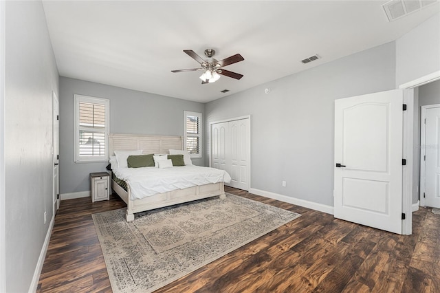 bedroom with ceiling fan, dark wood-type flooring, visible vents, and baseboards