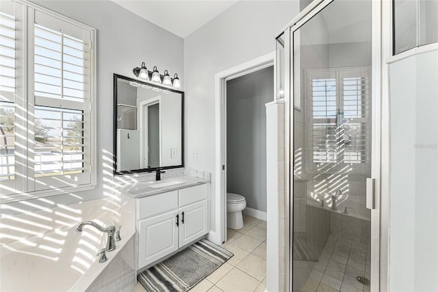 bathroom featuring tile patterned floors, vanity, toilet, and a healthy amount of sunlight