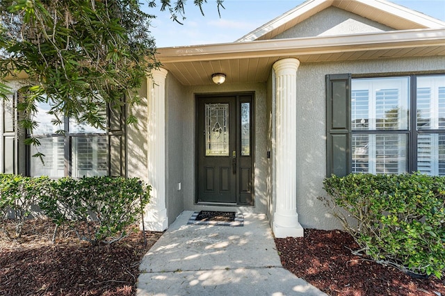 view of exterior entry with stucco siding