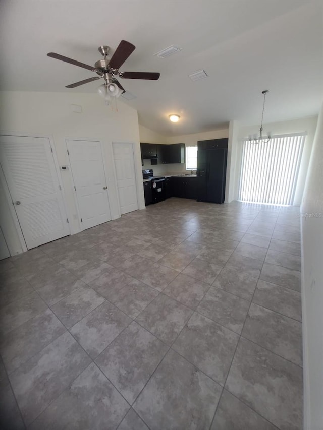 unfurnished living room featuring lofted ceiling, ceiling fan, and visible vents