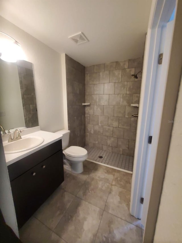 full bathroom with visible vents, vanity, toilet, and a shower stall