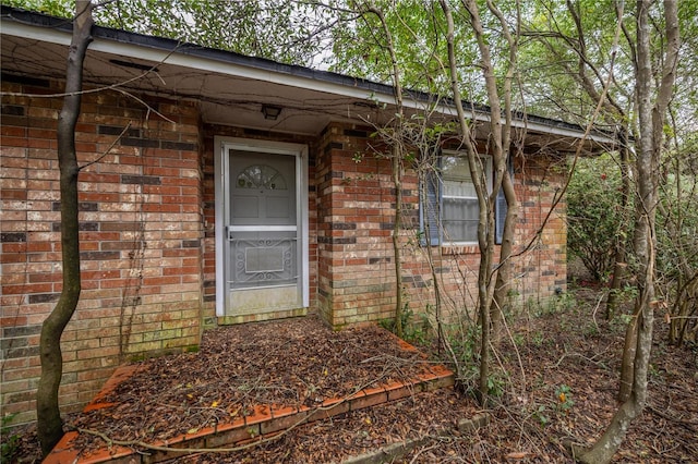 entrance to property with brick siding